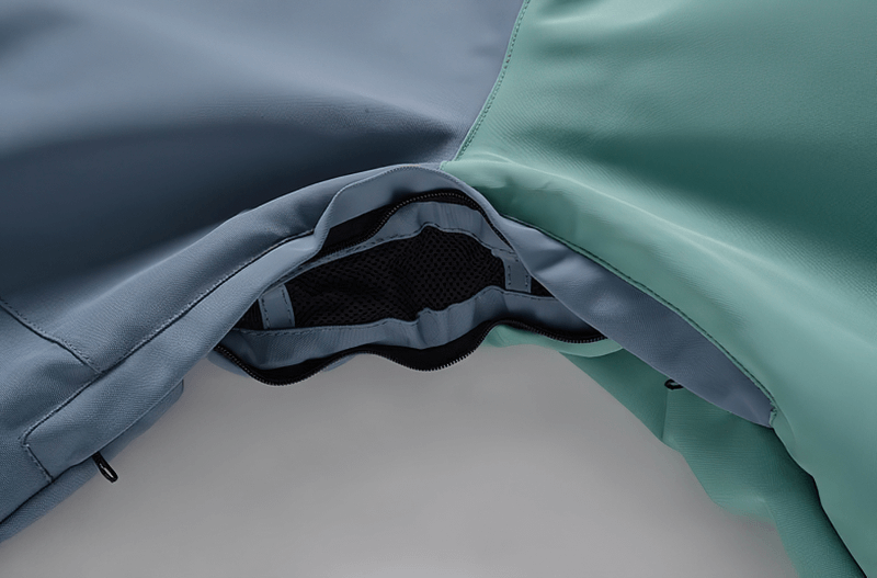 Close-up of the blue and green warm waterproof snowboarding jacket SF0943 showing inner double zipper details.